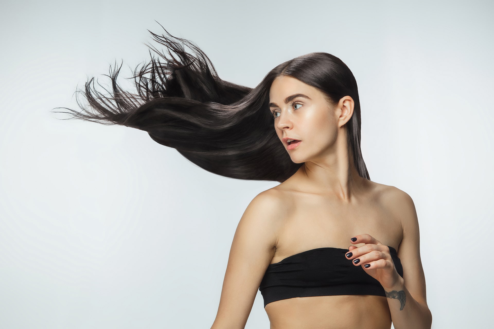 beautiful-model-with-long-smooth-flying-brunette-hair-isolated-white-studio-background